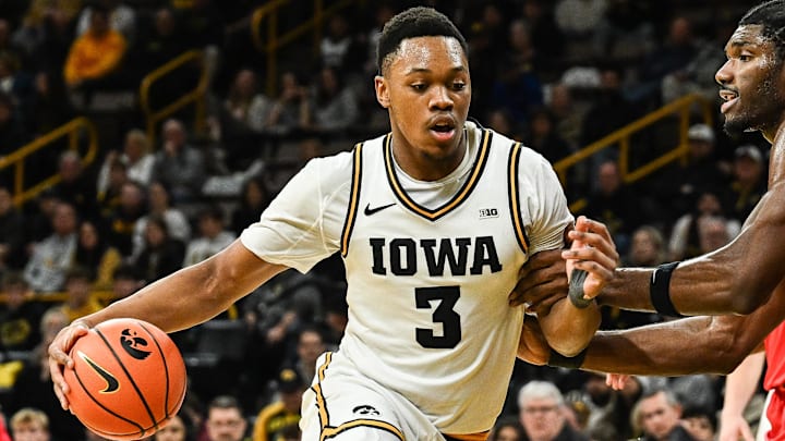 Jan 20, 2026; Iowa City, Iowa, USA; Iowa Hawkeyes forward Cam Manyawu (3) goes to the basket as Rutgers Scarlet Knights center Emmanuel Ogbole (21) defends during the 2nd half at Carver-Hawkeye Arena. Mandatory Credit: Jeffrey Becker-Imagn Images