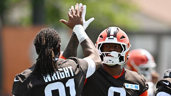 Cleveland Browns defensive end Alex Wright high-fives defensive end Jared Verse