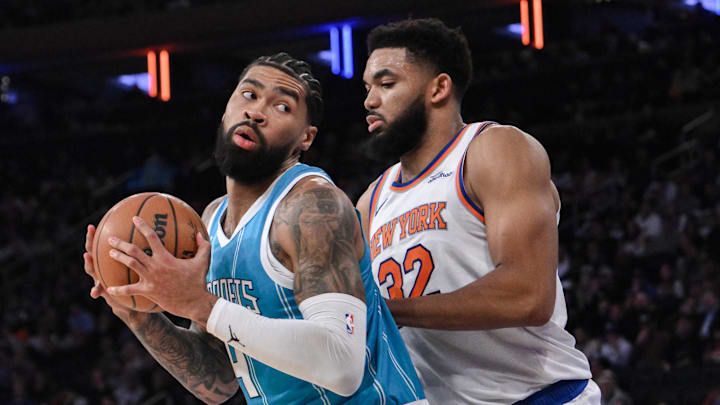 Dec 5, 2024; New York, New York, USA; Charlotte Hornets center Nick Richards (4) posts up against New York Knicks center Karl-Anthony Towns (32) during the first half at Madison Square Garden. Mandatory Credit: John Jones-Imagn Images