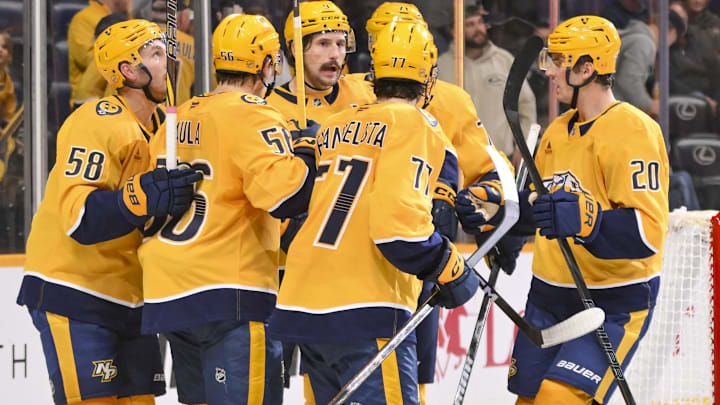 Oct 28, 2025; Nashville, Tennessee, USA;  Nashville Predators left wing Filip Forsberg (9) celebrates with his teammates after scoring a goal against the Tampa Bay Lightning during the third period at Bridgestone Arena. Mandatory Credit: Steve Roberts-Imagn Images