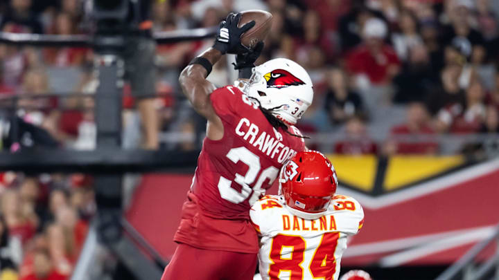 Aug 9, 2025; Glendale, Arizona, USA; Arizona Cardinals safety Kitan Crawford (36) intercepts a pass intended for Kansas City Chiefs wide receiver Mac Dalena (84) during a preseason NFL game at State Farm Stadium. Mandatory Credit: Mark J. Rebilas-Imagn Images