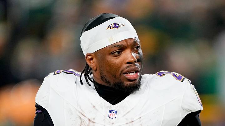 Dec 27, 2025; Green Bay, Wisconsin, USA; Baltimore Ravens running back Derrick Henry (22) talks to a referee during the second quarter against the Green Bay Packers at Lambeau Field. Mandatory Credit: Jeff Hanisch-Imagn Images
