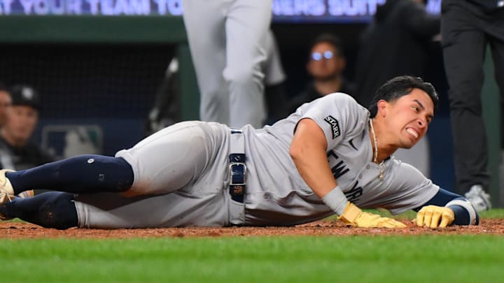May 12, 2025; Seattle, Washington, USA; New York Yankees third baseman Oswaldo Cabrera (95) in pain after scoring a run against the Seattle Mariners during the eighth inning at T-Mobile Park. Mandatory Credit: Steven Bisig-Imagn Images