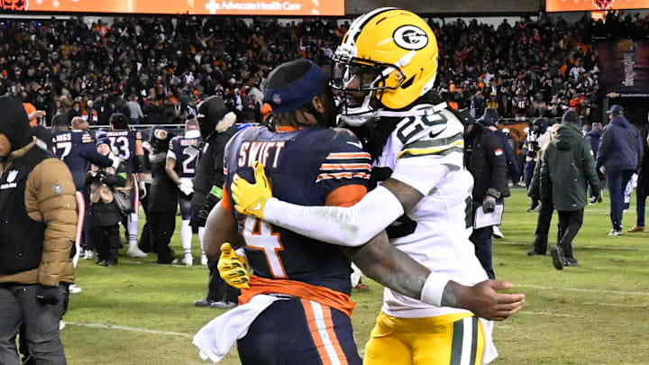 Jan 10, 2026; Chicago, IL, USA; in Chicago Bears running back D'Andre Swift (4) and Green Bay Packers cornerback Trevon Diggs (28) hug after an NFC Wild Card Round game at Soldier Field.