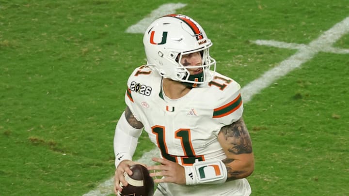 Jan 19, 2026; Miami Gardens, FL, USA; Miami Hurricanes quarterback Carson Beck (11) scrambles with the ball against the Indiana Hoosiers in the third quarter during the College Football Playoff National Championship game at Hard Rock Stadium. Mandatory Credit: Kim Klement Neitzel-Imagn Images