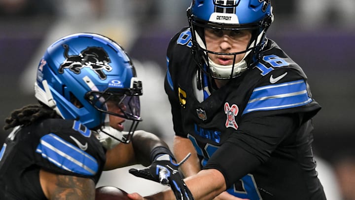 Detroit Lions quarterback Jared Goff (16) hands off the ball to running back Jahmyr Gibbs (0) 
