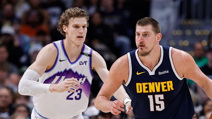 Dec 22, 2025; Denver, Colorado, USA; Denver Nuggets center Nikola Jokic (15) controls the ball as Utah Jazz forward Lauri Markkanen (23) guards in the second quarter at Ball Arena.