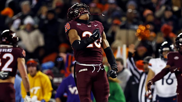 Nov 30, 2024; Blacksburg, Virginia, USA; Virginia Tech Hokies linebacker Caleb Woodson (20) celebrates after a play during the second quarter against the Virginia Cavaliers at Lane Stadium. Mandatory Credit: Peter Casey-Imagn Images