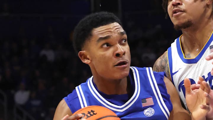 Feb 10, 2026; Pittsburgh, Pennsylvania, USA;  Duke Blue Devils guard Caleb Foster (1) dribbles the ball as Pittsburgh Panthers forward Cameron Corhen (right) defends during the second half at Petersen Events Center. Mandatory Credit: Charles LeClaire-Imagn Images