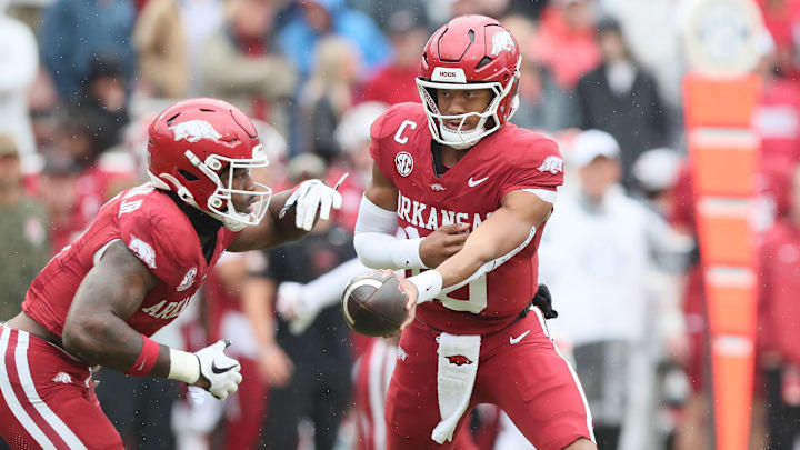 Arkansas Razorbacks quarterback Taylen Green (10) hands off to running back Mike Washington Jr (4) during the first quarter against the Auburn Tigers at Donald W. Reynolds Razorback Stadium.