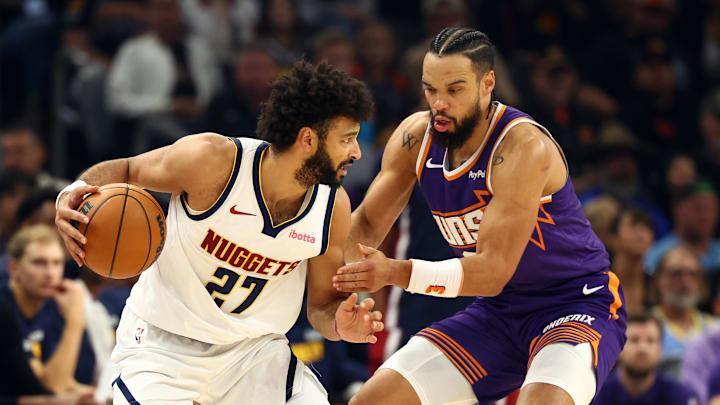 Nov 29, 2025; Phoenix, Arizona, USA; Denver Nuggets guard Jamal Murray (27) against Phoenix Suns forward Dillon Brooks in the first half at the Mortgage Matchup Center.