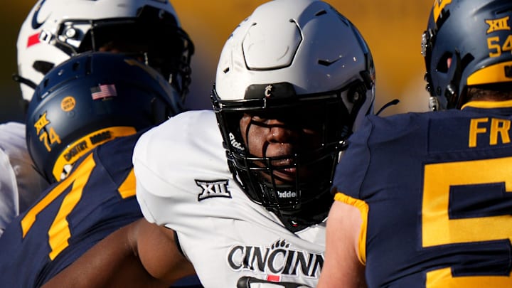 Cincinnati Bearcats defensive lineman Dontay Corleone (2) rushes the quarterback as West Virginia Mountaineers offensive lineman Zach Frazier (54) blocks in the first quarter during an NCAA college football game between the Cincinnati Bearcats and the West Virginia Mountaineers, Saturday, Nov. 18, 2023, at Milan Puskar Stadium in Morgantown, W. Va. Cincinnati Bearcats defensive lineman Dontay Corleone (2) rushes the quarterback as West Virginia Mountaineers offensive lineman Zach Frazier (54) blocks in the first quarter during an NCAA college football game between the Cincinnati Bearcats and the West Virginia Mountaineers, Saturday, Nov. 18, 2023, at Milan Puskar Stadium in Morgantown, W. Va.
