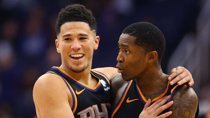 Dec 15, 2018; Phoenix, AZ, USA; Phoenix Suns guard Devin Booker (1) celebrates with Jamal Crawford against the Minnesota Timberwolves at Talking Stick Resort Arena. Mandatory Credit: Mark J. Rebilas-Imagn Images