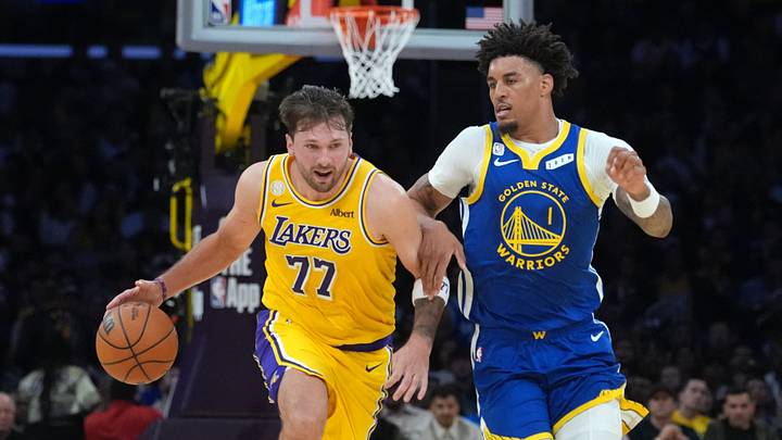 Oct 21, 2026; Los Angeles, California, USA; Los Angeles Lakers guard Luka Doncic (77) drives to the basket against Golden State Warriors forward Yaxel Lendeborg (1) in the first half at Crypto.com Arena. Mandatory Credit: Kirby Lee-Imagn Images