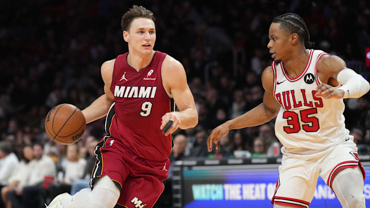 Jan 31, 2026; Miami, Florida, USA;  Miami Heat guard Pelle Larsson (9) brings the ball top the court as Chicago Bulls forward Isaac Okoro (35) defends during the second half at Kaseya Center. Mandatory Credit: Jim Rassol-Imagn Images