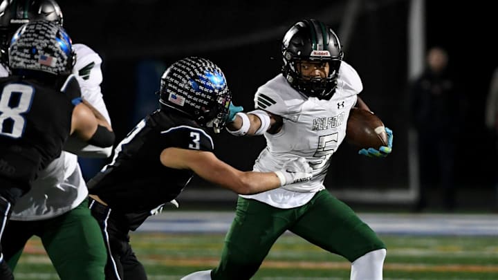 Decatur's Gavin Solito (3) tackles Milford Mill's Damon Ferguson (5) Friday, Nov. 24, 2023, in the 2A State Semifinal in Berlin, Maryland. Decatur defeated Milford Mill 35-34.