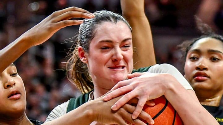 Michigan State's Grace VanSlooten, center, is pressured by, from left, Michigan's Te'Yala Delfosse, Mila Holloway and Kendall Dudley during overtime on Sunday, Feb. 1, 2026, at the Breslin Center in East Lansing.