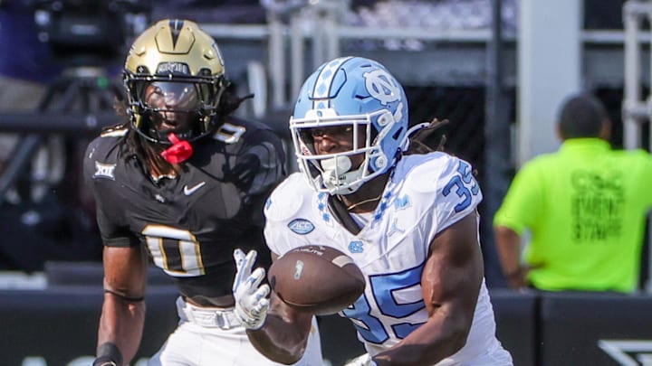 Sep 20, 2025; Orlando, Florida, USA; Carolina Tar Heels running back Demon June (35) catches a pass during the second quarter against the UCF Knights at the Bounce House Stadium. Sep 20, 2025; Orlando, Florida, USA; Carolina Tar Heels running back Demon June (35) catches a pass during the second quarter against the UCF Knights at the Bounce House Stadium.