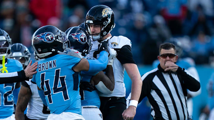 Tennessee running back Julius Chestnut (36), center, and Jacksonville punter Logan Cooke (9) get into a skirmish after a Jacksonville punt in the fourth quarter of their game at Nissan Stadium Sunday, Nov. 30, 2025.