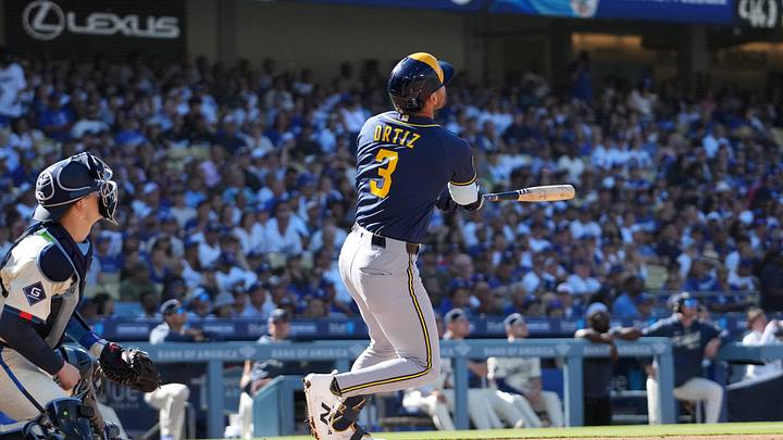 Aug 15, 2026; Los Angeles, California, USA; Milwaukee Brewers shortstop Joey Ortiz (3) hits a two-run home run as Los Angeles Dodgers catcher Hunter Feduccia (46) and home plate umpire Doug Eddings (88) watch at Dodger Stadium. Mandatory Credit: Kirby Lee-Imagn Images Aug 15, 2026; Los Angeles, California, USA; Milwaukee Brewers shortstop Joey Ortiz (3) hits a two-run home run as Los Angeles Dodgers catcher Hunter Feduccia (46) and home plate umpire Doug Eddings (88) watch at Dodger Stadium. Mandatory Credit: Kirby Lee-Imagn Images