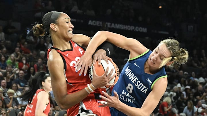 Aug 2, 2025; Las Vegas, Nevada, USA;  Las Vegas Aces center A'ja Wilson (22) and Minnesota Lynx forward Alanna Smith (8) battle for a rebound during the second quarter of their game at Michelob Ultra Arena. Mandatory Credit: Candice Ward-Imagn Images