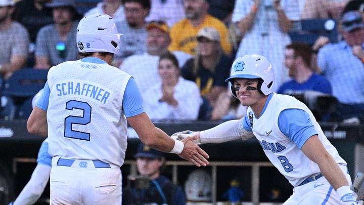 Jun 14, 2026; Omaha, NE, USA; North Carolina Tar Heels shortstop Jake Schaffner (2) and center fielder Owen Hull (8) celebrate scoring against the West Virginia Mountaineers during the seventh inning at Charles Schwab Field. Mandatory Credit: Steven Branscombe-Imagn Images Jun 14, 2026; Omaha, NE, USA; North Carolina Tar Heels shortstop Jake Schaffner (2) and center fielder Owen Hull (8) celebrate scoring against the West Virginia Mountaineers during the seventh inning at Charles Schwab Field. Mandatory Credit: Steven Branscombe-Imagn Images