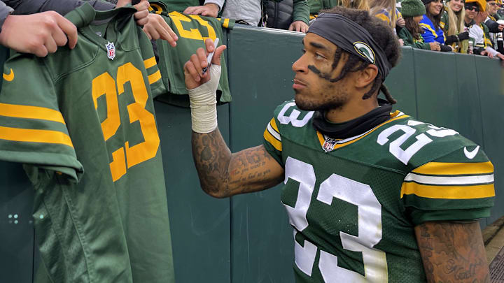 Green Bay Packers cornerback Jaire Alexander (23) signs autographs for fans after their game against the Los Angeles Rams at Lambeau Field.