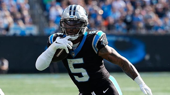 Nov 9, 2025; Charlotte, North Carolina, USA; Carolina Panthers running back Rico Dowdle (5) rushes as New Orleans Saints safety Justin Reid (21) defends during the first quarter at Bank of America Stadium. Mandatory Credit: Jim Dedmon-Imagn Images | Jim Dedmon-Imagn Images