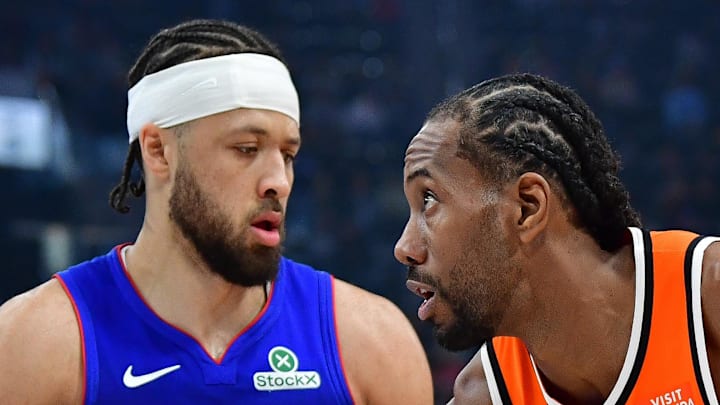 Los Angeles Clippers forward Kawhi Leonard controls the ball against Detroit Pistons guard Cade Cunningham.