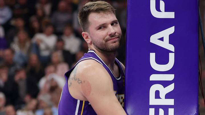 Dec 18, 2025; Salt Lake City, Utah, USA;  Los Angeles Lakers forward/guard Luka Doncic (77) hugs the stanchion after a foul during the first quarter against the Utah Jazz at Delta Center. Mandatory Credit: Chris Nicoll-Imagn Images