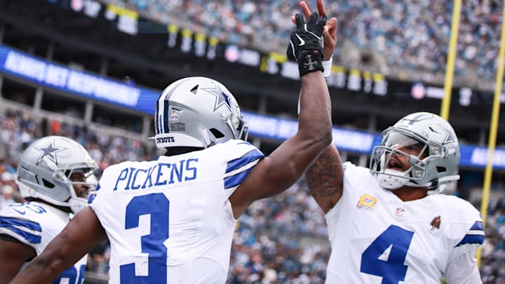 Dallas Cowboys WR George Pickens celebrates with QB Dak Prescott during the first half at Bank of America Stadium.