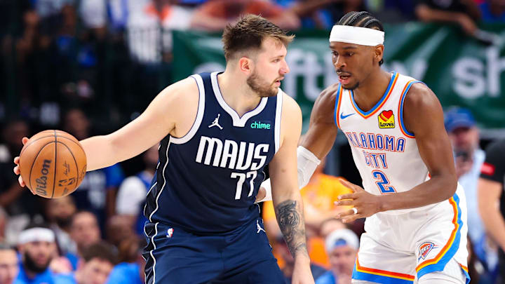 May 11, 2024; Dallas, Texas, USA; Dallas Mavericks guard Luka Doncic (77) controls the ball as Oklahoma City Thunder guard Shai Gilgeous-Alexander (2) defends during the second half during game three of the second round for the 2024 NBA playoffs at American Airlines Center. Mandatory Credit: Kevin Jairaj-Imagn Images