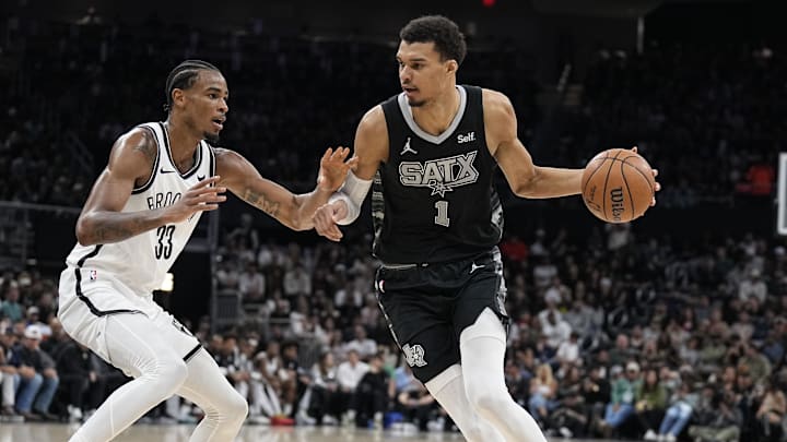 Mar 17, 2024; Austin, Texas, USA; San Antonio Spurs forward Victor Wembanyama (1) drives to the basket while defended by Brooklyn Nets center Nicolas Claxton (33) during the first half at Moody Center.