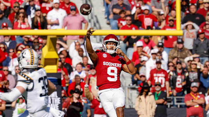 Dec 27, 2024; Fort Worth, TX, USA; Oklahoma Sooners quarterback Michael Hawkins Jr. (9) throws a touchdown pass during the first quarter against the Navy Midshipmen at Amon G. Carter Stadium. Dec 27, 2024; Fort Worth, TX, USA; Oklahoma Sooners quarterback Michael Hawkins Jr. (9) throws a touchdown pass during the first quarter against the Navy Midshipmen at Amon G. Carter Stadium.