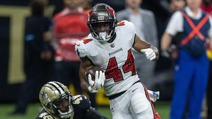 Oct 13, 2024; New Orleans, Louisiana, USA;  Tampa Bay Buccaneers running back Sean Tucker (44) runs away from the tackle of New Orleans Saints safety J.T. Gray (48) during the first half at Caesars Superdome. Mandatory Credit: Stephen Lew-Imagn Images