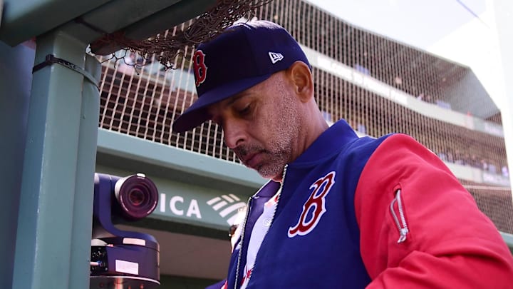 Apr 20, 2026; Boston, Massachusetts, USA; Boston Red Sox manager Alex Cora signs a baseball for a fan prior to a game against the Detroit Tigers at Fenway Park. Mandatory Credit: Bob DeChiara-Imagn Images