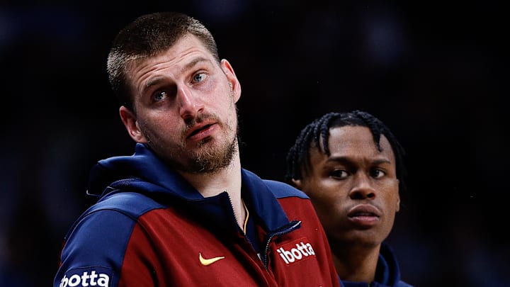 Apr 1, 2025; Denver, Colorado, USA; Denver Nuggets center Nikola Jokic (15) and forward Peyton Watson (8) look on from the sideline in the second quarter against the Minnesota Timberwolves at Ball Arena. Mandatory Credit: Isaiah J. Downing-Imagn Images
