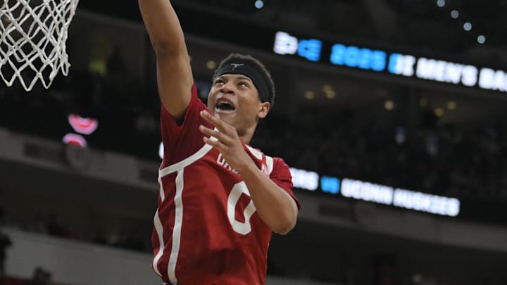 Mar 21, 2025; Raleigh, NC, USA;  Oklahoma Sooners guard Jeremiah Fears (0) puts up shot against Connecticut Huskies forward Liam McNeeley (30) during the second half at Lenovo Center. Mandatory Credit: Zachary Taft-Imagn Images