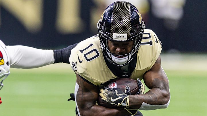 New Orleans Saints wide receiver Brandin Cooks is tackled by Arizona Cardinals defenders.