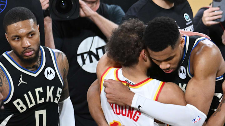Dec 14, 2024; Las Vegas, Nevada, USA; Milwaukee Bucks forward Giannis Antetokounmpo (34) and Atlanta Hawks guard Trae Young (11) embrace after a semifinal of the 2024 Emirates NBA Cup at T-Mobile Arena. Mandatory Credit: Candice Ward-Imagn Images