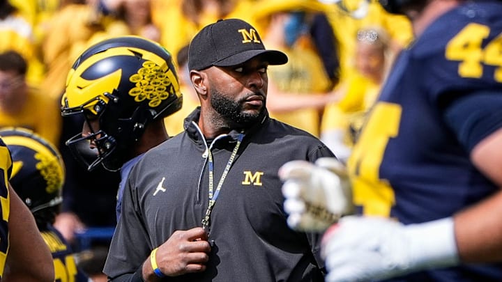 Michigan head coach Sherrone Moore, center, watches warmups before the No. 9 Wolverines' 31-12 loss to No. 3 Texas at Michigan Stadium in Ann Arbor on Saturday, Sept. 7, 2024.