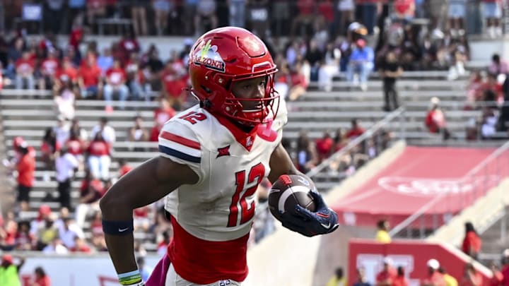Oct 18, 2025; Houston, Texas, USA; Arizona Wildcats wide receiver Tre Spivey (12) runs the ball in for a touchdown during the fourth quarter against the Houston Cougars at TDECU Stadium. Mandatory Credit: Maria Lysaker-Imagn Images Oct 18, 2025; Houston, Texas, USA; Arizona Wildcats wide receiver Tre Spivey (12) runs the ball in for a touchdown during the fourth quarter against the Houston Cougars at TDECU Stadium. Mandatory Credit: Maria Lysaker-Imagn Images