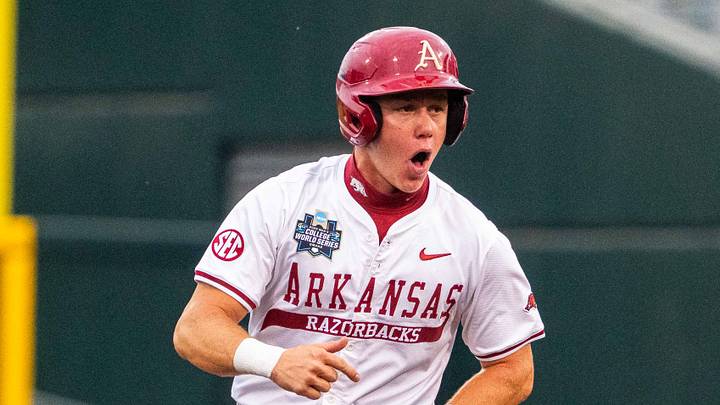 Jun 17, 2025; Omaha, Neb, USA; Arkansas Razorbacks left fielder Charles Davalan (24) celebrates after a two-run home run by shortstop Wehiwa Aloy (9) against the UCLA Bruins during the first inning at Charles Schwab Field. Mandatory Credit: Dylan Widger-Imagn Images Jun 17, 2025; Omaha, Neb, USA; Arkansas Razorbacks left fielder Charles Davalan (24) celebrates after a two-run home run by shortstop Wehiwa Aloy (9) against the UCLA Bruins during the first inning at Charles Schwab Field. Mandatory Credit: Dylan Widger-Imagn Images
