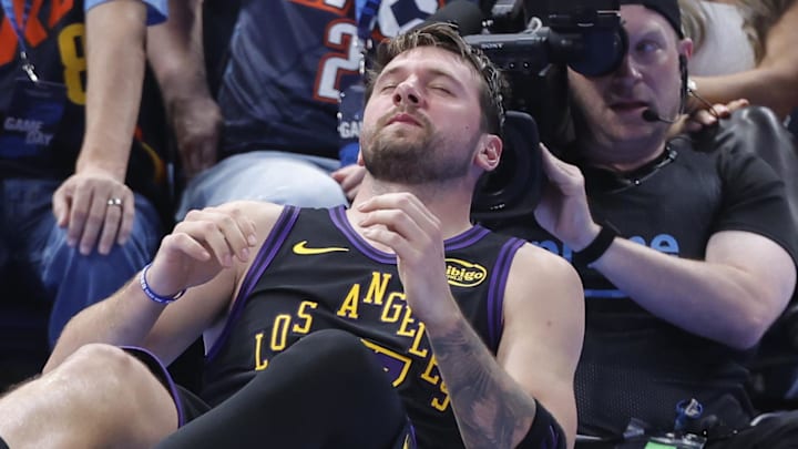Apr 2, 2026; Oklahoma City, Oklahoma, USA; Los Angeles Lakers guard Luka Doncic (77) falls to the court during a play against the Oklahoma City Thunder during the third quarter at Paycom Center. Mandatory Credit: Alonzo Adams-Imagn Images