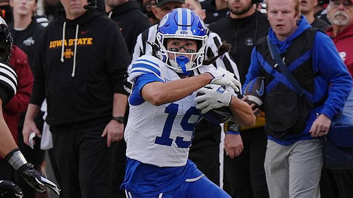BYU Cougars wide receiver Tiger Bachmeier (19) runs with the ball around Iowa State Cyclones' defensive back Cam Smith (13) after making a catch during the third quarter at Jack Trice Stadium on Oct. 25, 2025, in Ames, Iowa.