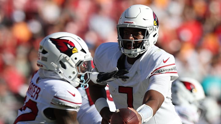 Nov 30, 2025; Tampa, Florida, USA; Arizona Cardinals quarterback Jacoby Brissett (7) hands off to running back Michael Carter (22) during the second half against the Tampa Bay Buccaneers at Raymond James Stadium. Mandatory Credit: Nathan Ray Seebeck-Imagn Images