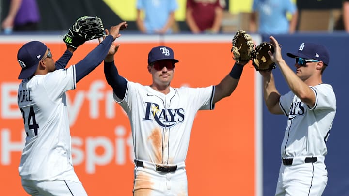 Mar 30, 2025; Tampa, Florida, USA; Tampa Bay Rays left fielder Christopher Morel (24), outfielder Jonny DeLuca (21) and right fielder Jake Magnum (28) celebrate after they beat the Colorado Rockies at George M. Steinbrenner Field. Mar 30, 2025; Tampa, Florida, USA; Tampa Bay Rays left fielder Christopher Morel (24), outfielder Jonny DeLuca (21) and right fielder Jake Magnum (28) celebrate after they beat the Colorado Rockies at George M. Steinbrenner Field.