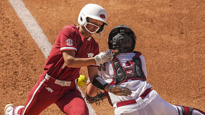 Arkansas utility Raigan Kramer (1) scores a run past the Oklahoma catcher at Jack Turner Softball Stadium. 
