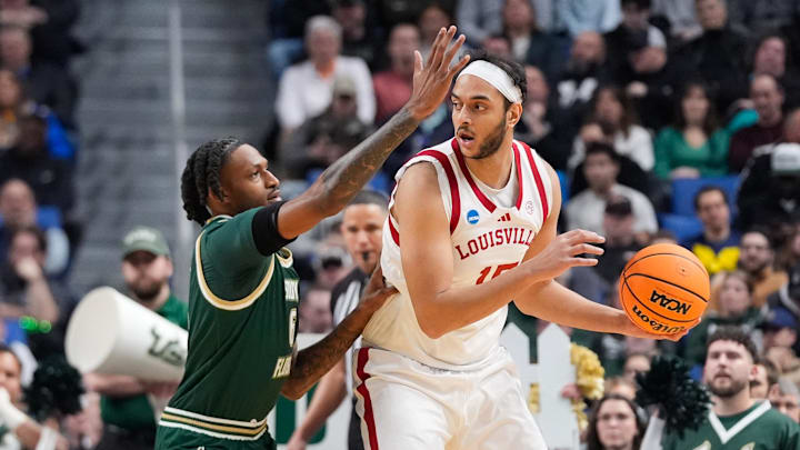 Mar 19, 2026; Buffalo, NY, USA; Louisville Cardinals center Aly Khalifa (15) looks to pass as South Florida Bulls forward Daimion Collins (6) defends during the first half during a first round game of the men's 2026 NCAA Tournament at Keybank Center. Mandatory Credit: Gregory Fisher-Imagn Images Mar 19, 2026; Buffalo, NY, USA; Louisville Cardinals center Aly Khalifa (15) looks to pass as South Florida Bulls forward Daimion Collins (6) defends during the first half during a first round game of the men's 2026 NCAA Tournament at Keybank Center. Mandatory Credit: Gregory Fisher-Imagn Images