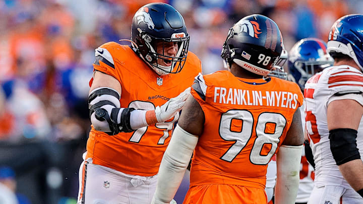 Oct 19, 2025; Denver, Colorado, USA; Denver Broncos defensive end Zach Allen (99) celebrates his sack with defensive end John Franklin-Myers (98) in the fourth quarter against the New York Giants at Empower Field at Mile High. 